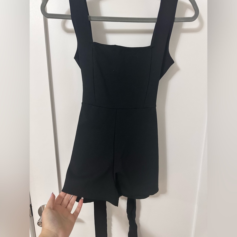 Never worn black romper with a belt attached nice for any occasion!